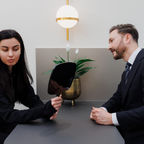 UltraClear laser consultation London patient examining skin with mirror during treatment assessment